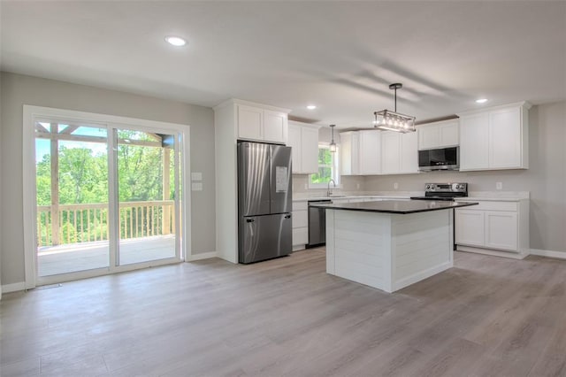 405 Julie Ln, Holts Summit, MO 65043 - kitchen with stainless steel appliances, baseboards, light wood-style floors, white cabinetry, and recessed lighting