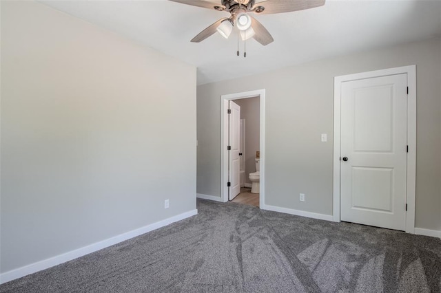 405 Julie Ln, Holts Summit, MO 65043 - unfurnished bedroom with carpet, baseboards, connected bathroom, and ceiling fan