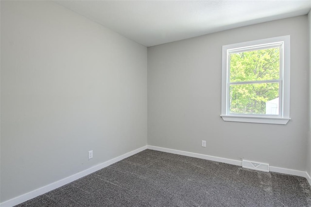 405 Julie Ln, Holts Summit, MO 65043 - spare room featuring dark carpet and baseboards