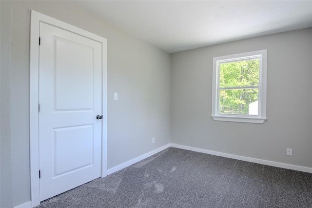 405 Julie Ln, Holts Summit, MO 65043 - unfurnished room featuring dark carpet and baseboards