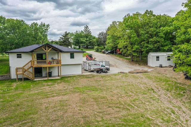 405 Julie Ln, Holts Summit, MO 65043 - back of property featuring a wooden deck, stairway, and a yard
