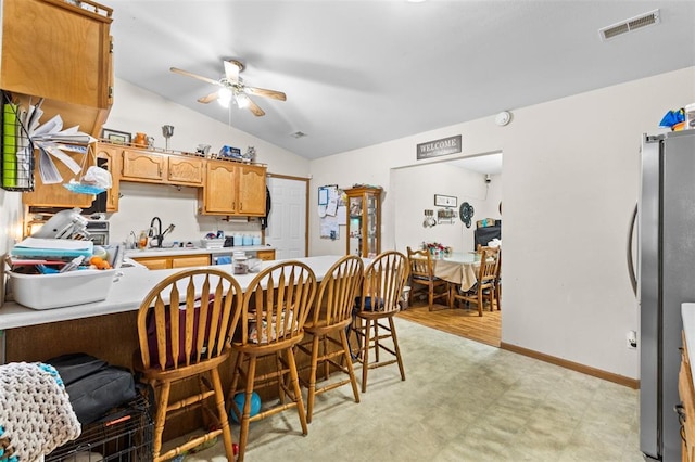 114 Edwards Ln, Park Hills, MO 63601 - kitchen featuring vaulted ceiling, light countertops, freestanding refrigerator, ceiling fan, and a sink