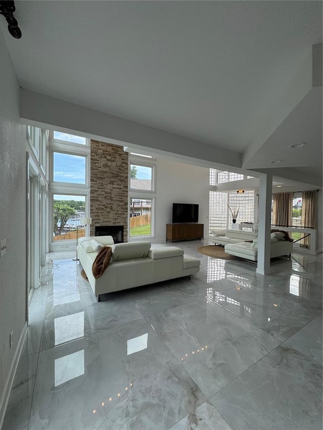149 Thornwood Cir, Sunrise Beach, MO 65079 - living area with marble tiled floors and a stone fireplace