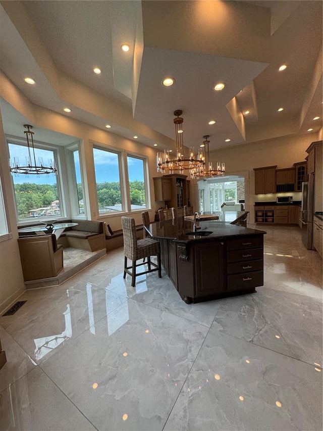 149 Thornwood Cir, Sunrise Beach, MO 65079 - kitchen with a sink, dark countertops, a chandelier, light marble finish flooring, and recessed lighting