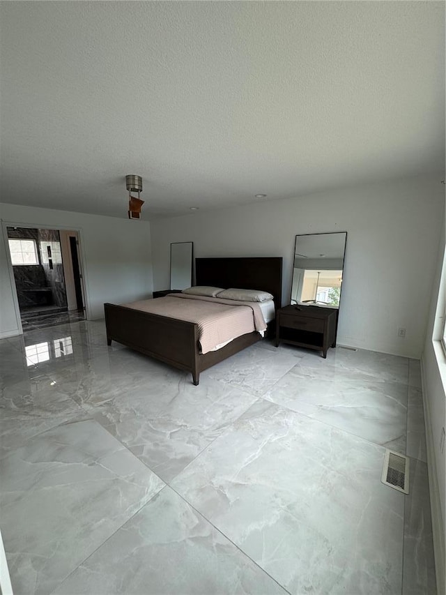 149 Thornwood Cir, Sunrise Beach, MO 65079 - bedroom featuring marble finish flooring and a textured ceiling