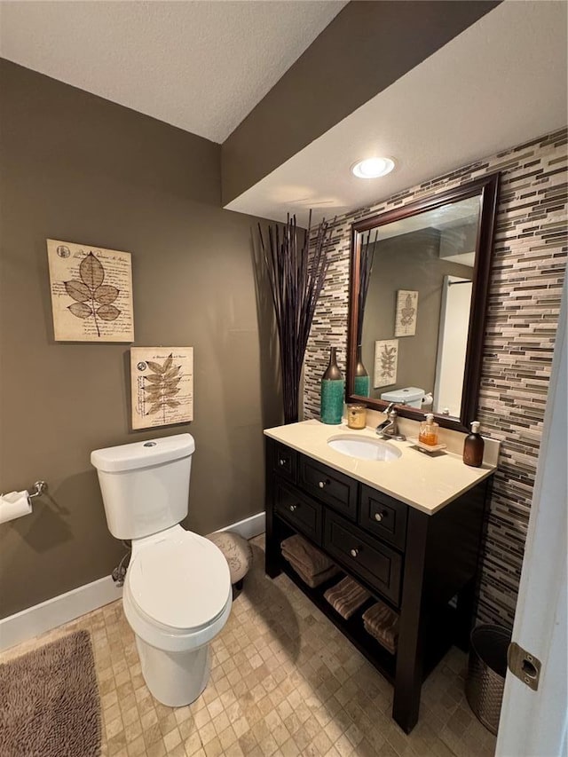 149 Thornwood Cir, Sunrise Beach, MO 65079 - half bathroom with baseboards, toilet, vanity, and a textured ceiling