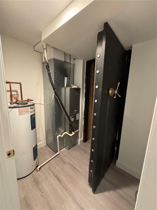149 Thornwood Cir, Sunrise Beach, MO 65079 - utility room featuring electric water heater and heating unit