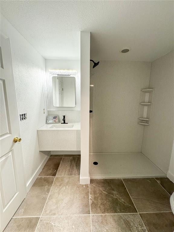 149 Thornwood Cir, Sunrise Beach, MO 65079 - bathroom featuring a walk in shower, vanity, baseboards, a textured ceiling, and toilet