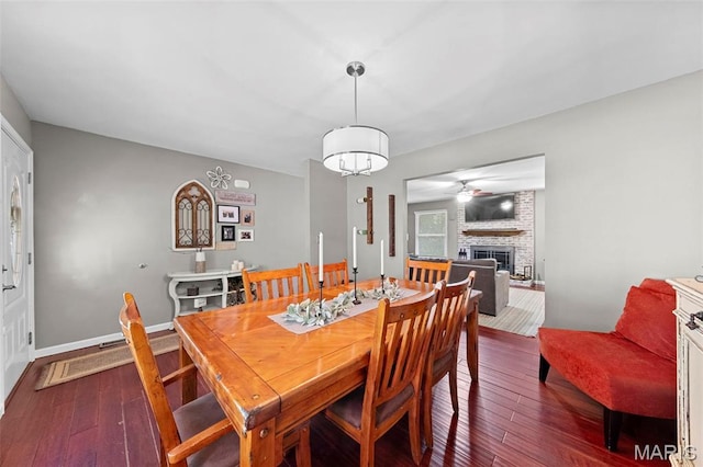 2917 Royal Gorge Ct, Oakville Township, MO 63129 - dining space with a fireplace, hardwood / wood-style flooring, a ceiling fan, and baseboards