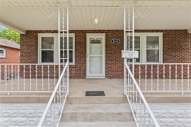 8838 Argyle Ave, Overland, MO 63114 - view of exterior entry with a porch and brick siding