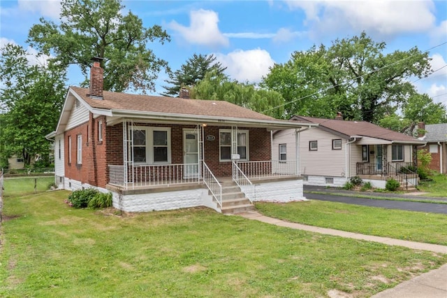 8838 Argyle Ave, Overland, MO 63114 - view of front of house featuring a chimney, a porch, brick siding, and a front yard