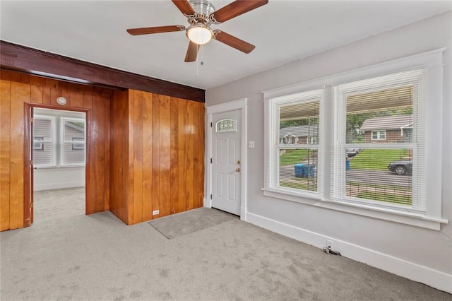 8838 Argyle Ave, Overland, MO 63114 - carpeted empty room featuring wooden walls, ceiling fan, and baseboards