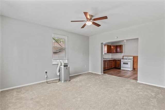8838 Argyle Ave, Overland, MO 63114 - unfurnished living room featuring dark colored carpet, ceiling fan, and baseboards