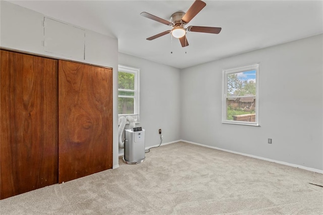 8838 Argyle Ave, Overland, MO 63114 - unfurnished bedroom featuring light carpet, baseboards, and ceiling fan