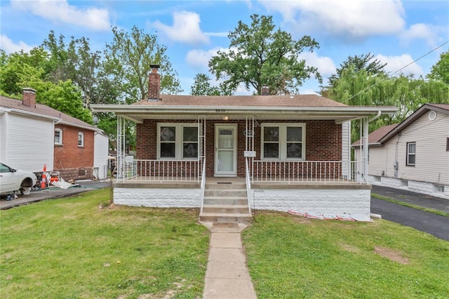 8838 Argyle Ave, Overland, MO 63114 - view of front of property featuring a porch, brick siding, and a front yard