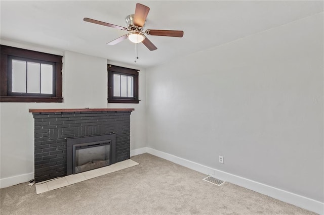 8838 Argyle Ave, Overland, MO 63114 - unfurnished living room with carpet floors, baseboards, a brick fireplace, and ceiling fan