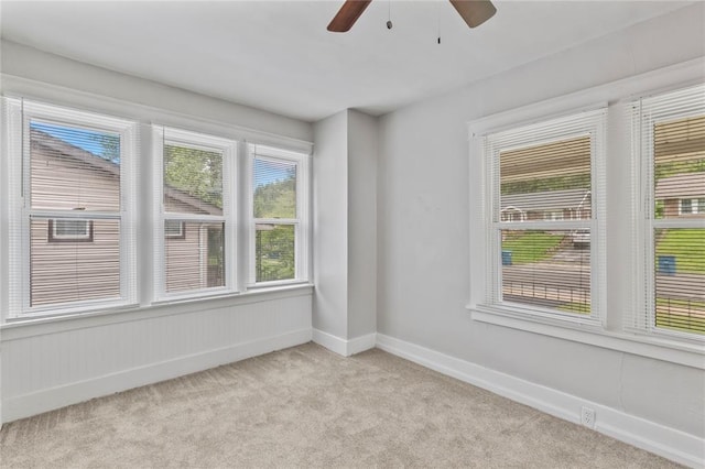 8838 Argyle Ave, Overland, MO 63114 - spare room featuring light colored carpet, a ceiling fan, and baseboards
