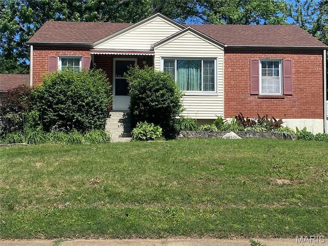 10521 Saint Henry Ln, Saint Ann, MO 63074 - view of front of house with a front yard, brick siding, and a shingled roof