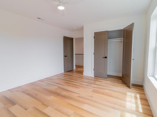 6343 Tholozan, Saint Louis, MO 63109 - unfurnished bedroom with light wood-style floors, baseboards, a closet, and a ceiling fan