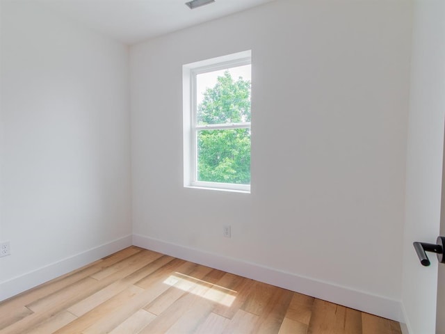 6343 Tholozan, Saint Louis, MO 63109 - spare room featuring healthy amount of natural light, baseboards, and wood finished floors
