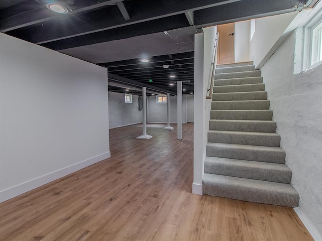6343 Tholozan, Saint Louis, MO 63109 - below grade area featuring stairway, wood finished floors, and baseboards