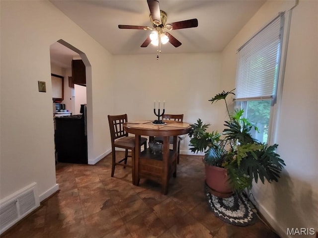 14 Banbury Ct, Crestwood, MO 63126 - dining area featuring arched walkways, a ceiling fan, and baseboards