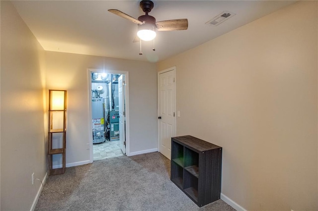 155 Roberts St, Jerseyville, IL 62052 - unfurnished bedroom featuring water heater, carpet, baseboards, and a ceiling fan
