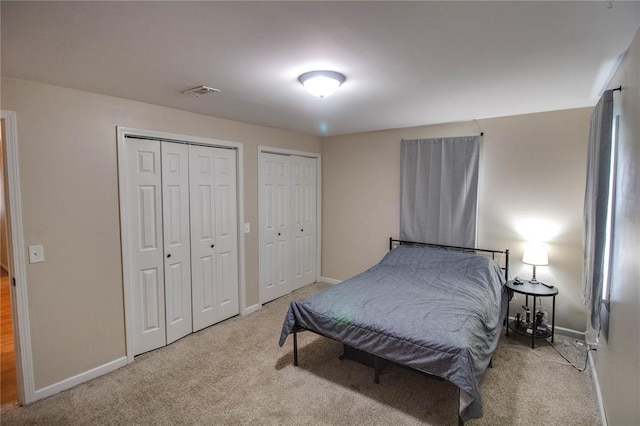 155 Roberts St, Jerseyville, IL 62052 - bedroom featuring multiple closets, carpet floors, and baseboards