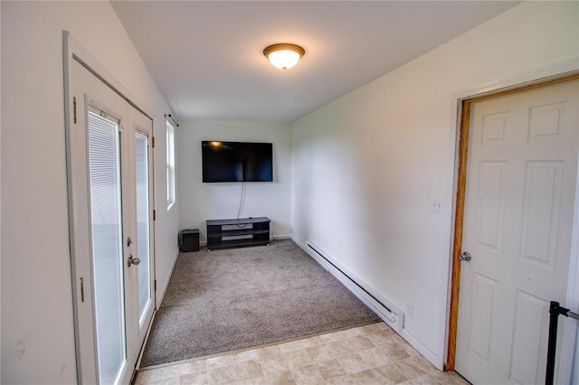 155 Roberts St, Jerseyville, IL 62052 - unfurnished living room featuring baseboard heating, light colored carpet, and baseboards
