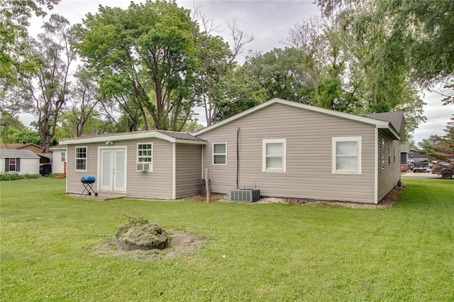 155 Roberts St, Jerseyville, IL 62052 - back of house featuring a lawn, central AC, an outdoor structure, and french doors