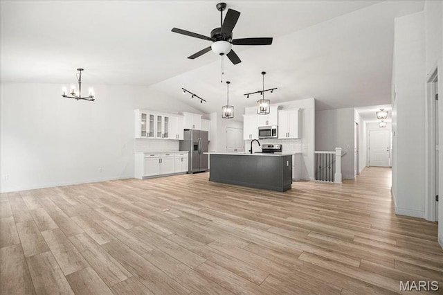346 Fairhaven Ct, Wright City, MO 63390 - unfurnished living room featuring vaulted ceiling, a chandelier, a ceiling fan, and light wood-style floors