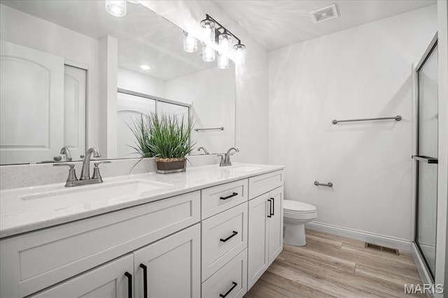 346 Fairhaven Ct, Wright City, MO 63390 - bathroom with double vanity, a stall shower, and wood finished floors