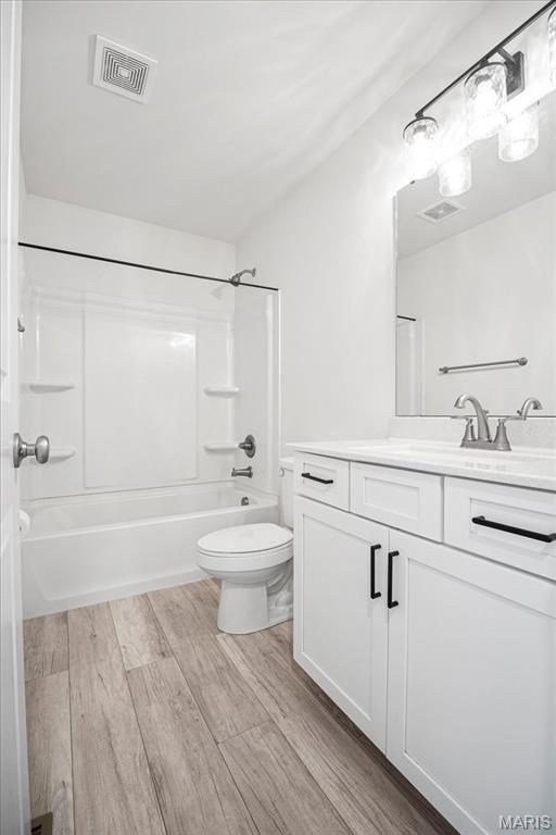 346 Fairhaven Ct, Wright City, MO 63390 - full bathroom with vanity, shower / tub combination, and wood finished floors