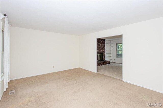 1461 Oak Bluff Ln, Kirkwood, MO 63122 - spare room with light carpet and a fireplace