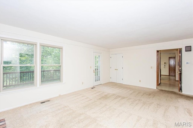 1461 Oak Bluff Ln, Kirkwood, MO 63122 - empty room featuring plenty of natural light and light carpet