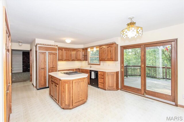 1461 Oak Bluff Ln, Kirkwood, MO 63122 - kitchen with black dishwasher, light countertops, brown cabinetry, stovetop, and a center island