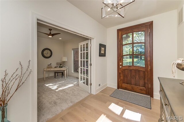 111 N Mosley Rd, Saint Louis, MO 63141 - foyer entrance featuring light wood finished floors and a chandelier