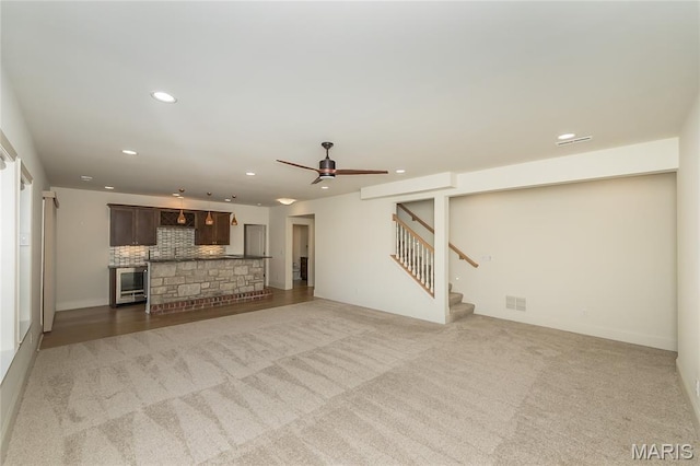 111 N Mosley Rd, Saint Louis, MO 63141 - unfurnished living room featuring wine cooler, ceiling fan, stairs, recessed lighting, and light carpet