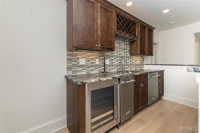 111 N Mosley Rd, Saint Louis, MO 63141 - bar area featuring beverage cooler, stainless steel dishwasher, light wood finished floors, tasteful backsplash, and recessed lighting
