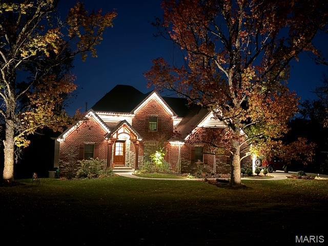 111 N Mosley Rd, Saint Louis, MO 63141 - view of front of house with a yard and brick siding