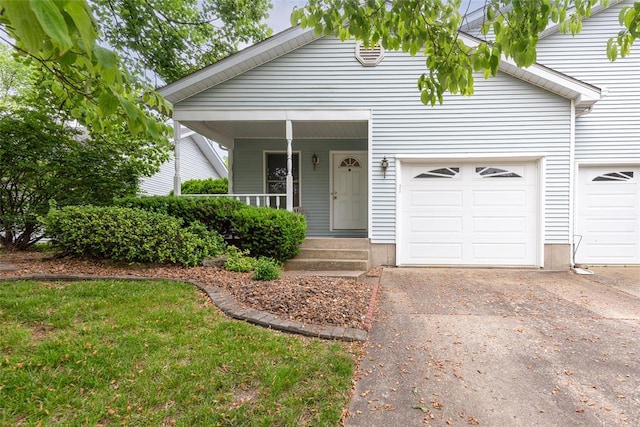 1118 Cobblestone Dr, Edwardsville, IL 62025 - view of front facade with an attached garage, driveway, and a porch