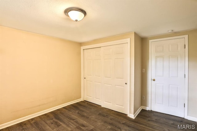 542 Meramec Station Rd Unit C, Valley Park, MO 63088 - unfurnished bedroom featuring a closet, dark wood-style flooring, and baseboards