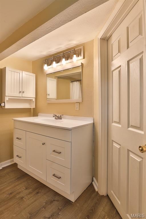 542 Meramec Station Rd Unit C, Valley Park, MO 63088 - bathroom featuring vanity, wood finished floors, and baseboards