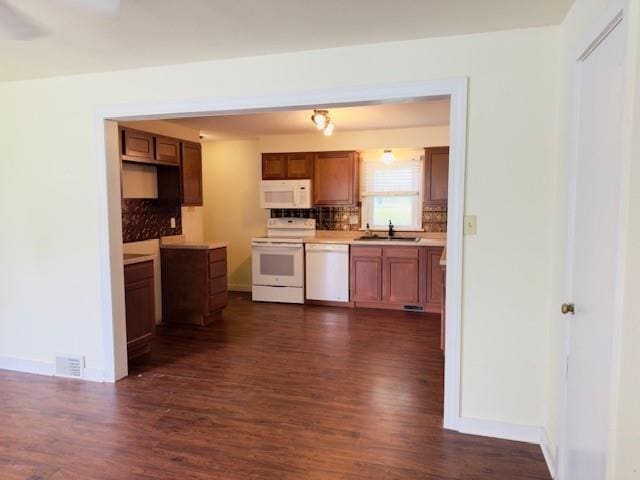 2722 Adeline St, Cape Girardeau, MO 63701 - kitchen with white appliances, dark wood-type flooring, decorative backsplash, and a sink