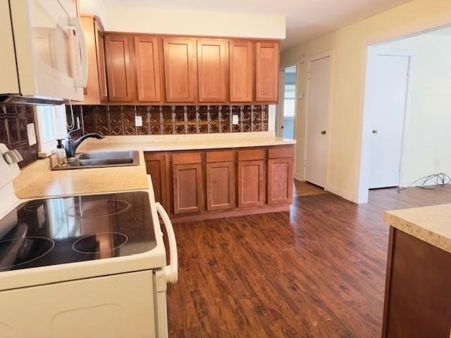 2722 Adeline St, Cape Girardeau, MO 63701 - kitchen featuring white appliances, light countertops, backsplash, dark wood-style flooring, and brown cabinetry
