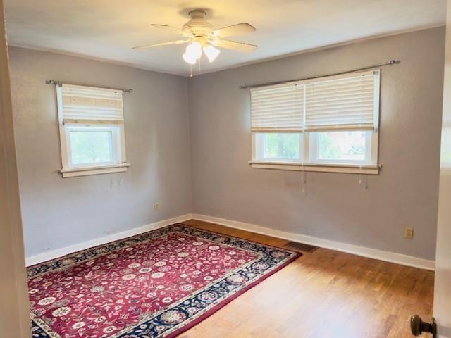 2722 Adeline St, Cape Girardeau, MO 63701 - empty room featuring plenty of natural light, wood finished floors, a ceiling fan, and baseboards