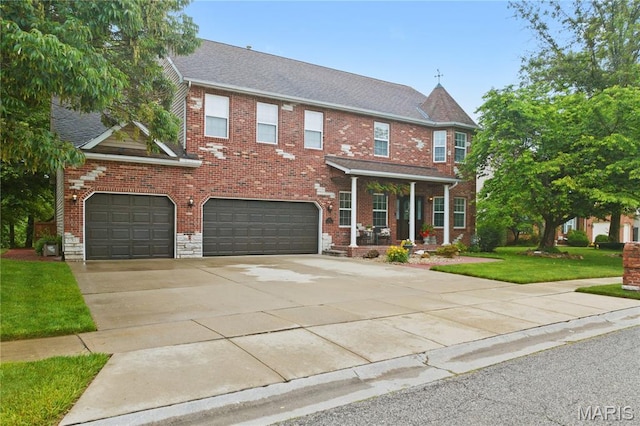 1171 Red Hawk Ridge Ln, Ofallon, IL 62269 - view of front of house featuring an attached garage, a front lawn, driveway, and brick siding