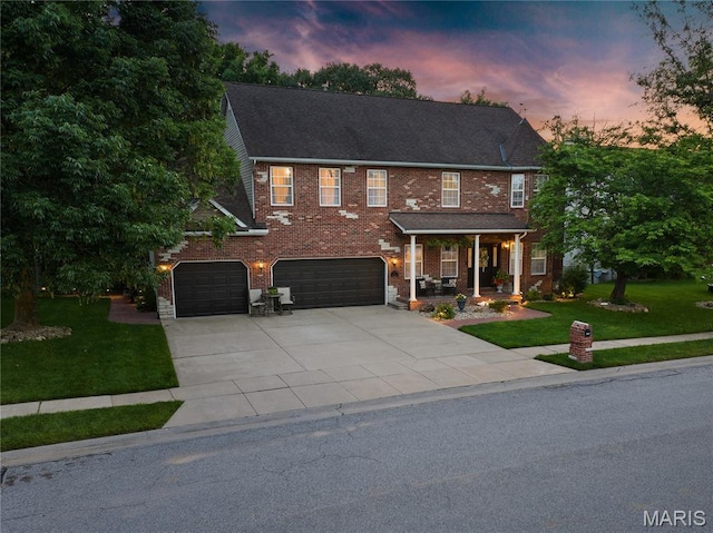 1171 Red Hawk Ridge Ln, Ofallon, IL 62269 - view of front of home with covered porch, a front lawn, driveway, and a garage