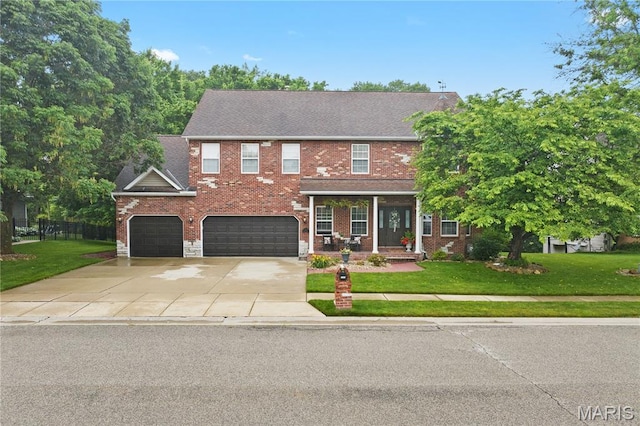 1171 Red Hawk Ridge Ln, Ofallon, IL 62269 - view of front facade featuring a front lawn, covered porch, concrete driveway, and a garage
