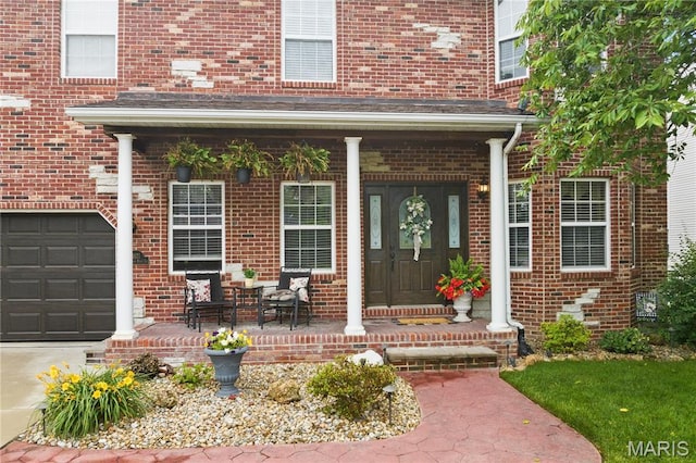 1171 Red Hawk Ridge Ln, Ofallon, IL 62269 - doorway to property featuring a porch, brick siding, and concrete driveway